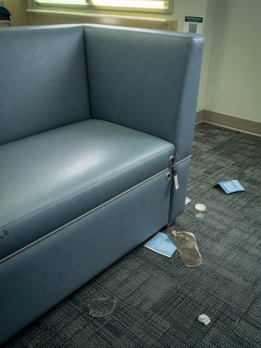 Ultra-realistic 8K close-up of hospitality-grade cleanable seating upholstery and durable commercial carpet tiles in a high-traffic clinic waiting room
